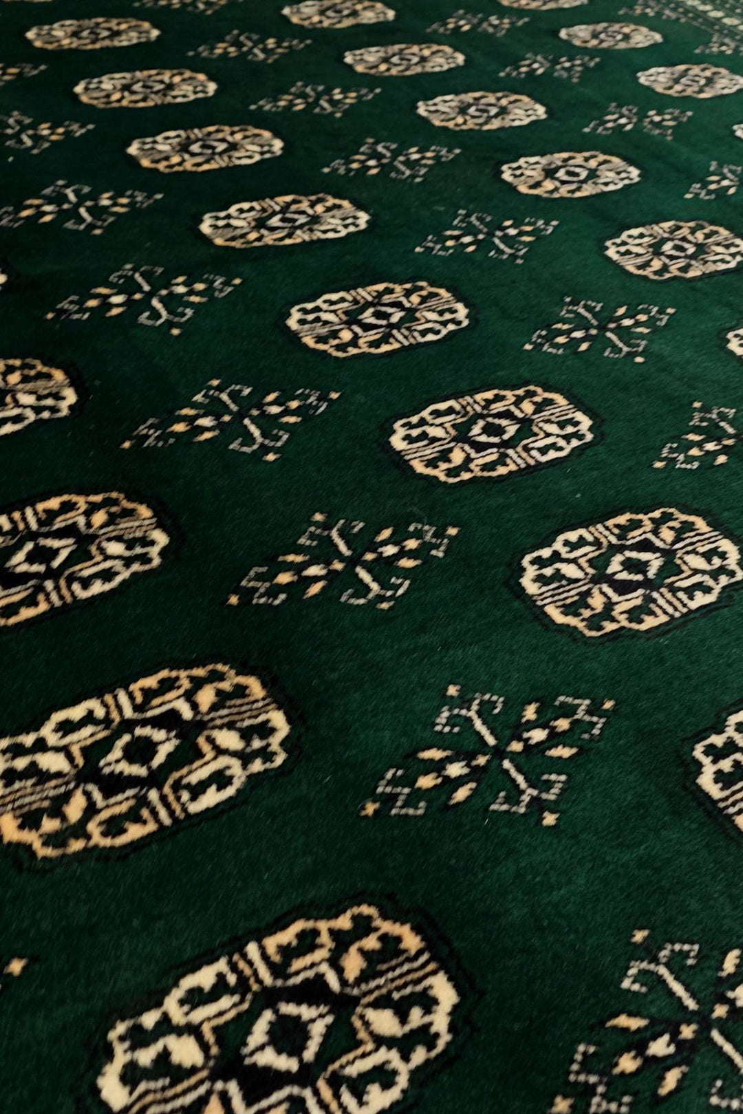 Hand-knotted wool pile of forest green Bokhara rug, 217×302cm