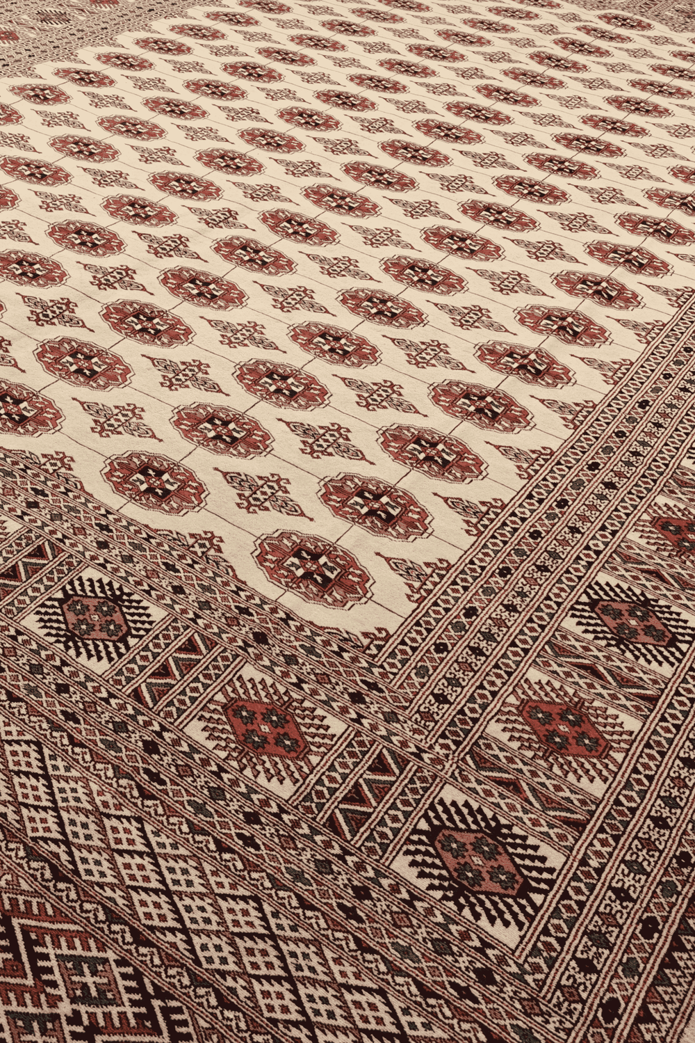 Turkmen gül motifs in ivory and rust on Pakistani Bokhara rug