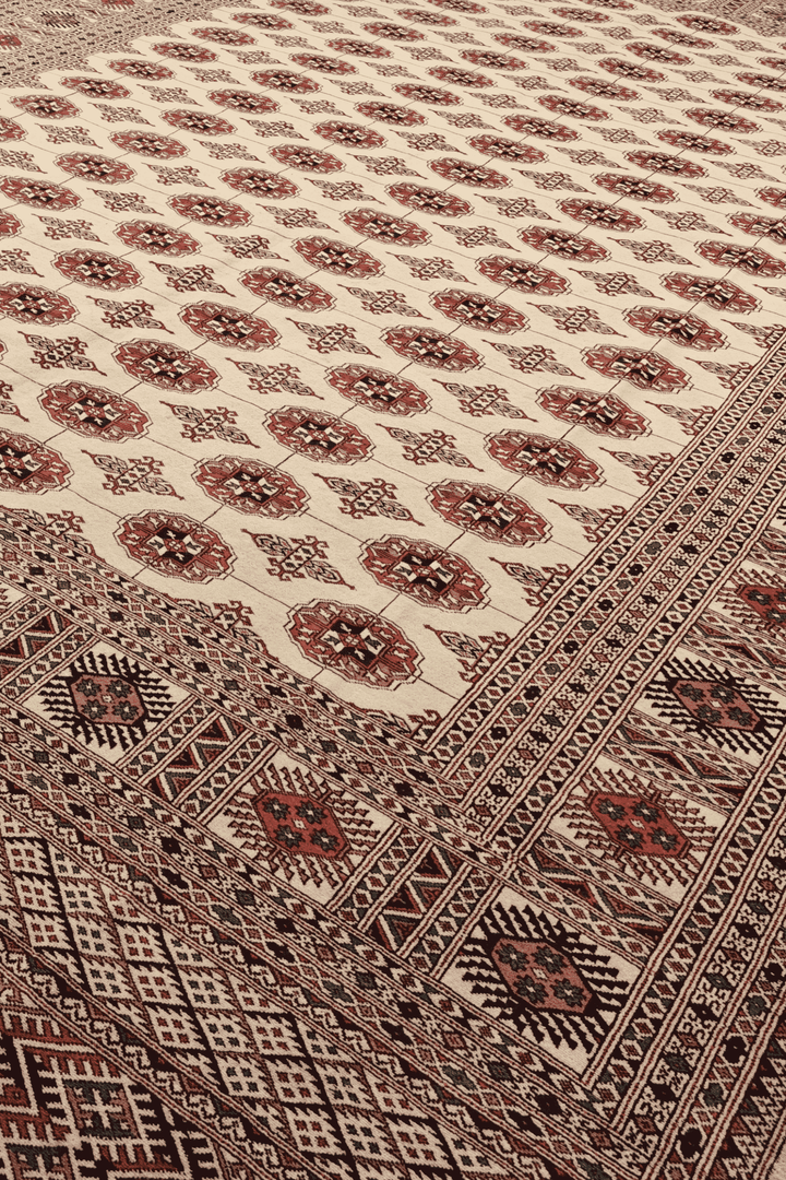 Turkmen gül motifs in ivory and rust on Pakistani Bokhara rug