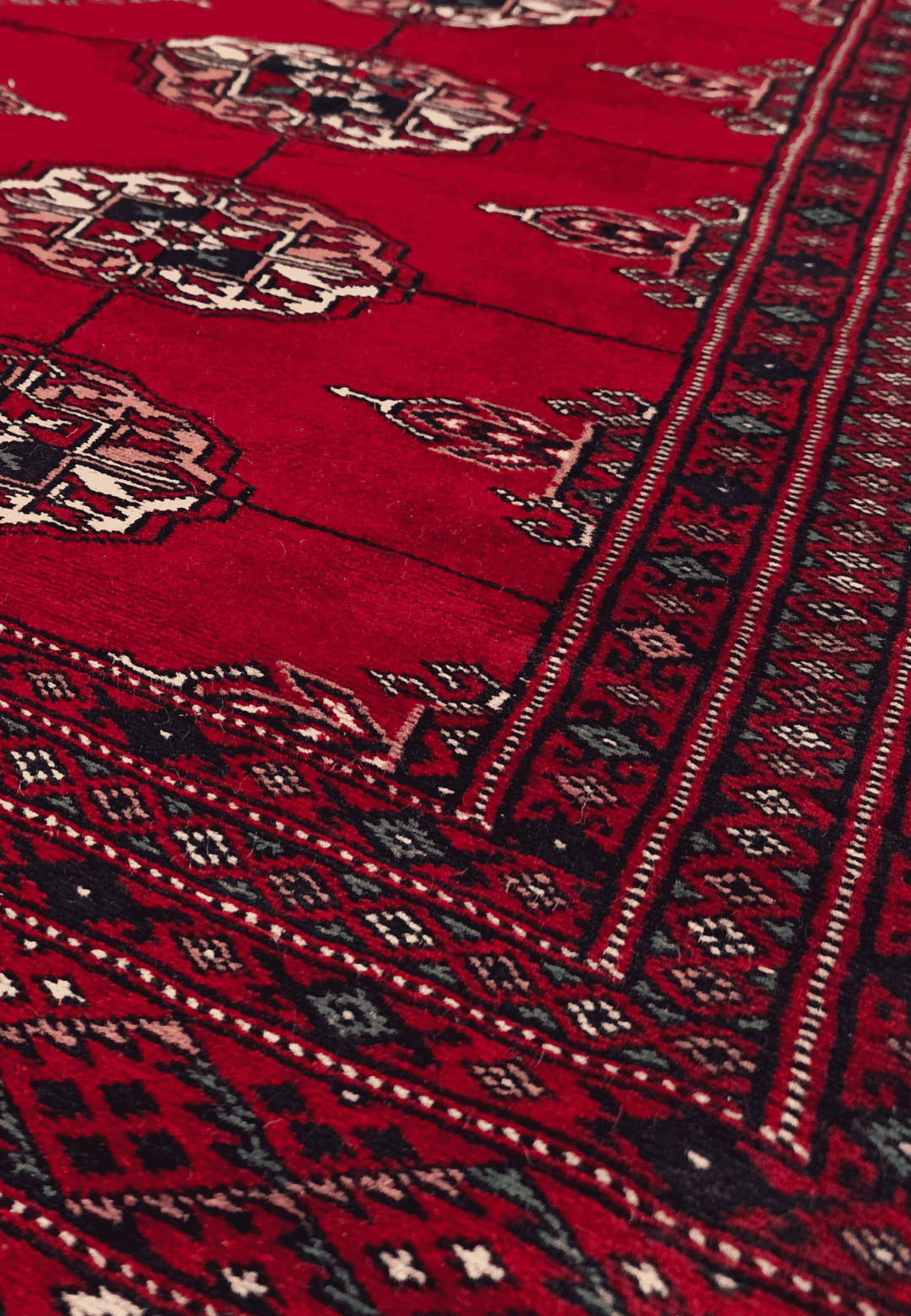 Turkmen gül motifs in madder red and ivory on small Bokhara rug