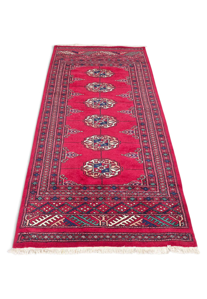 Hand-knotted wool pile of madder red Bokhara rug, 69×142cm