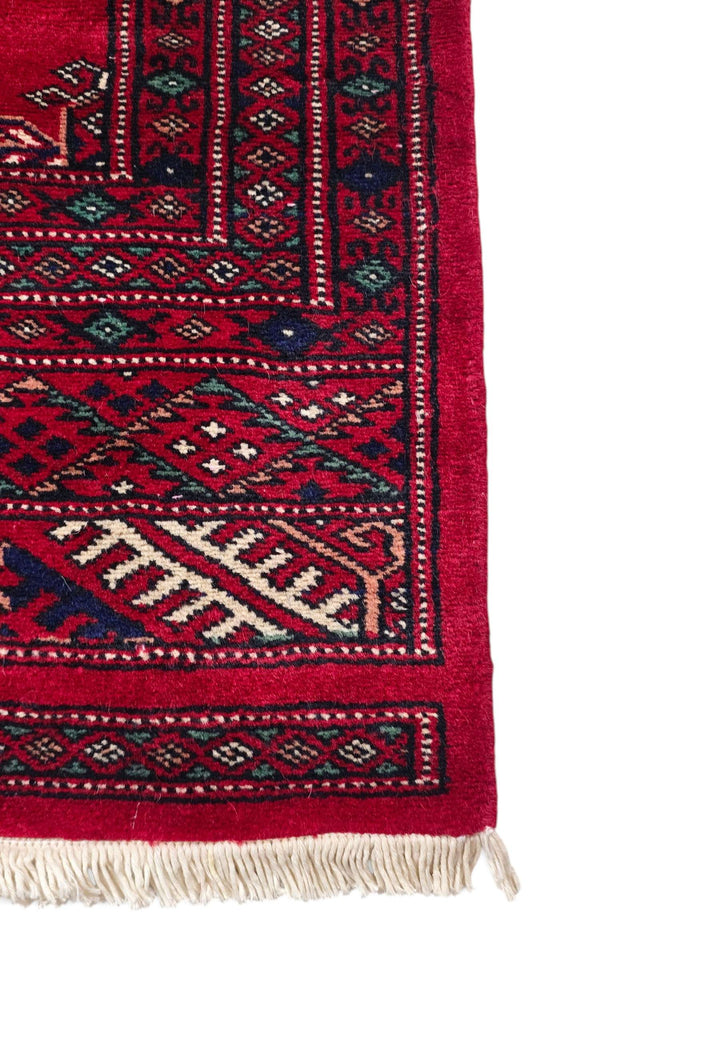 Hand-knotted madder red Bokhara rug with ivory Turkmen güls