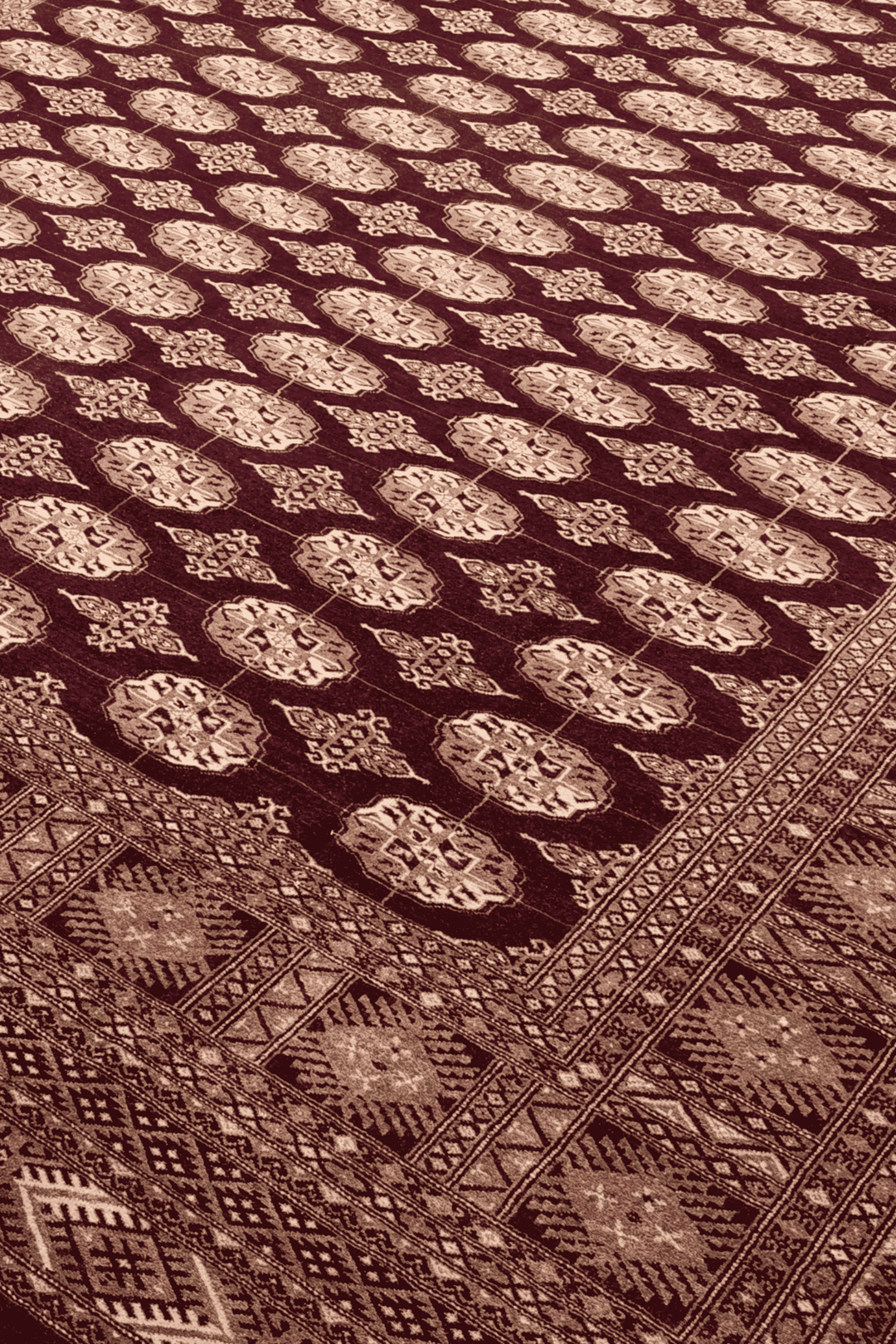 Alternating gül motifs in aubergine and tan on hand-knotted Bokhara rug