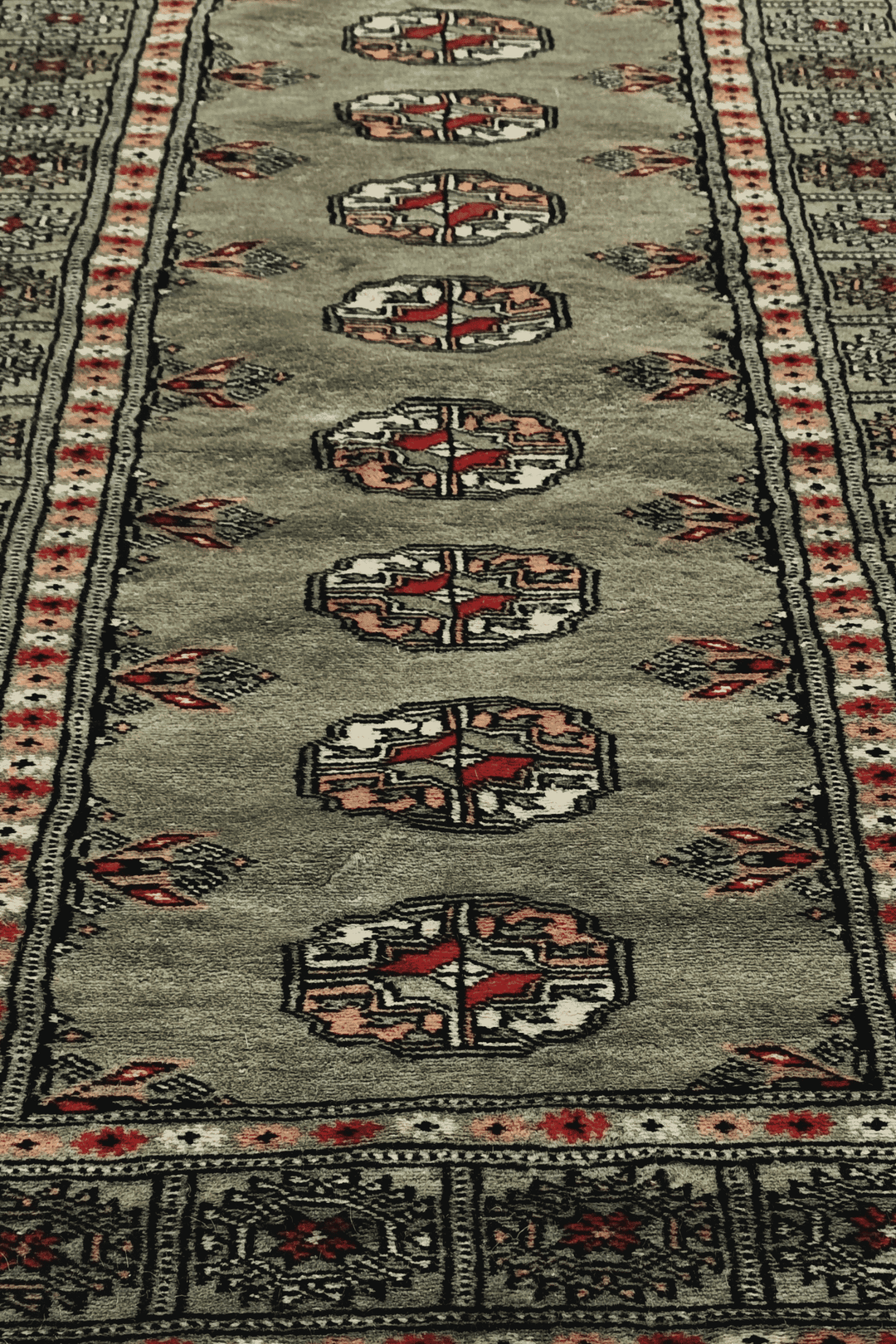 Hand-knotted olive Bokhara runner with peach Turkmen güls