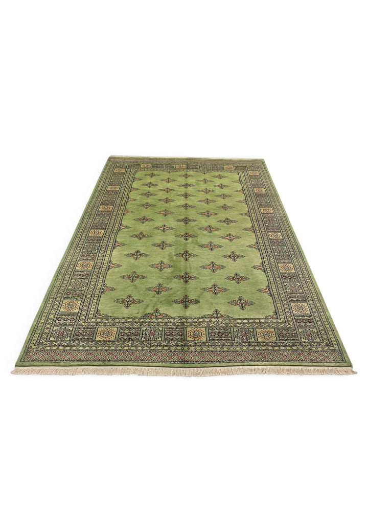 Border detail of olive green hand-knotted Bokhara rug, minimal design