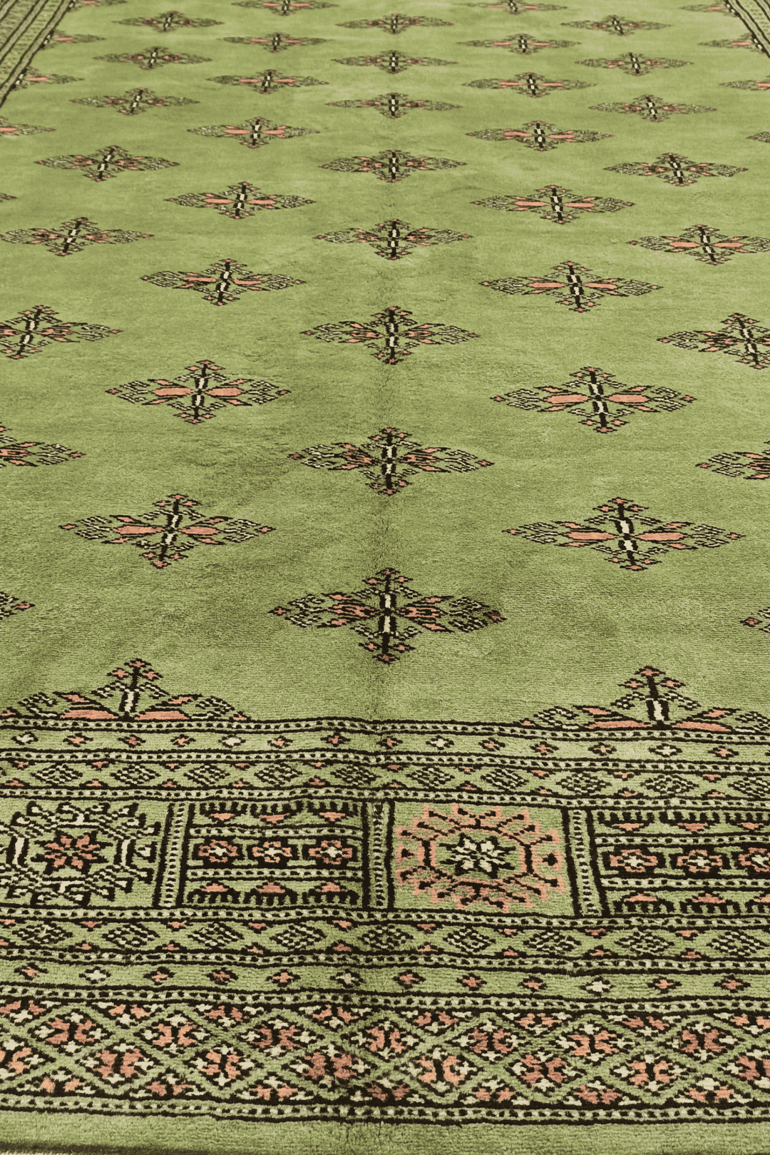 One-of-a-kind olive green open field Pakistani Bokhara rug