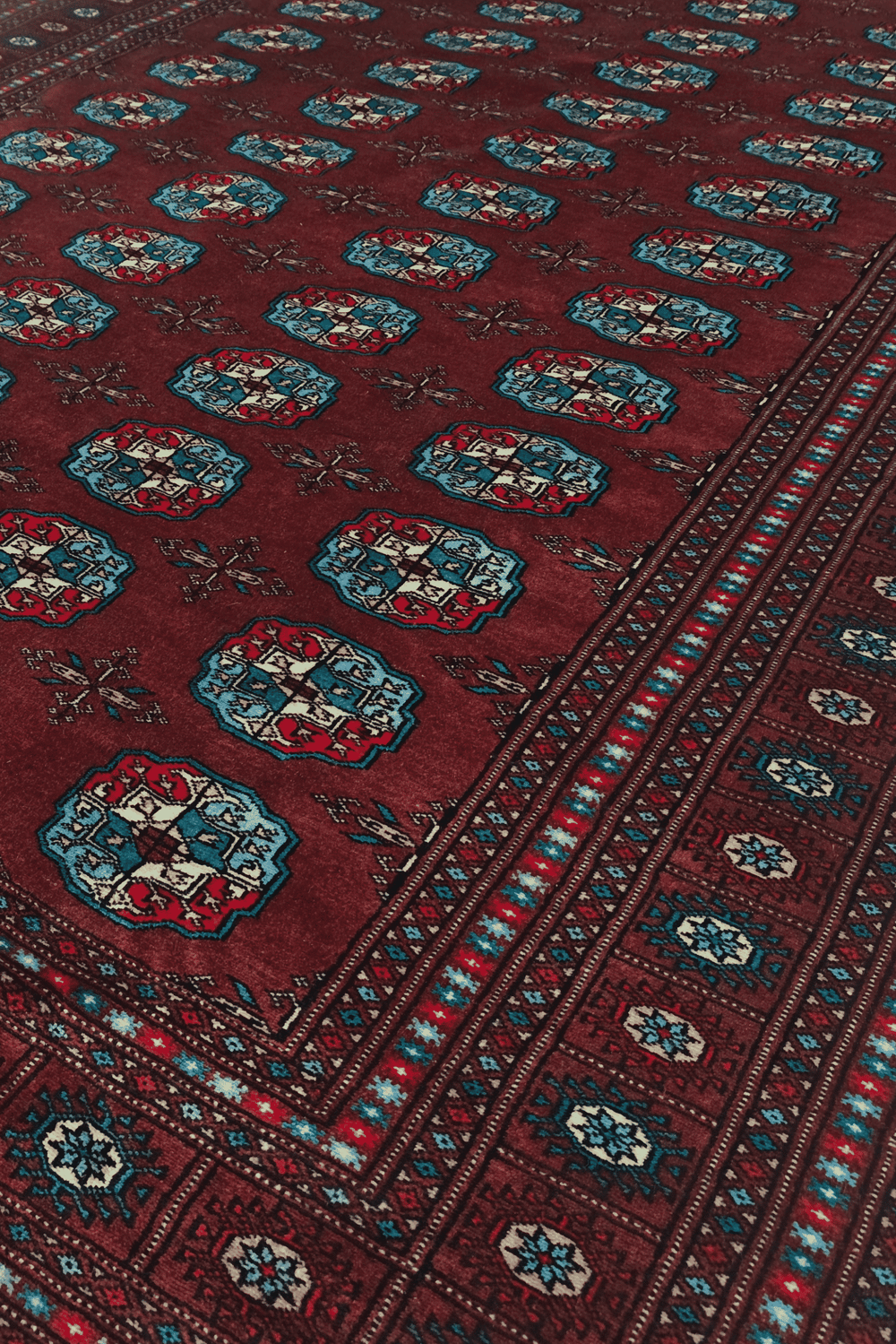 Turkmen gül motifs in oxblood and blue on Bokhara wool rug