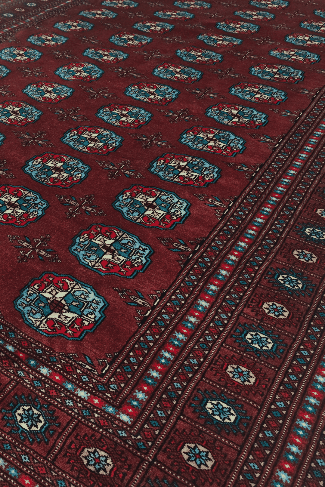 Turkmen gül motifs in oxblood and blue on Bokhara wool rug