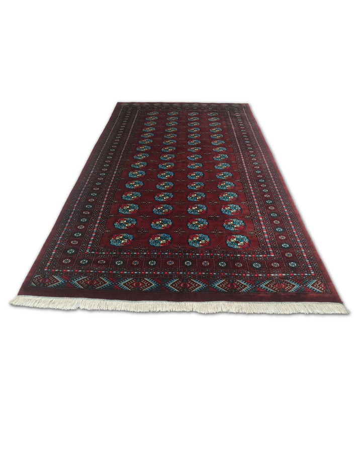Border detail of oxblood and blue hand-knotted Bokhara rug