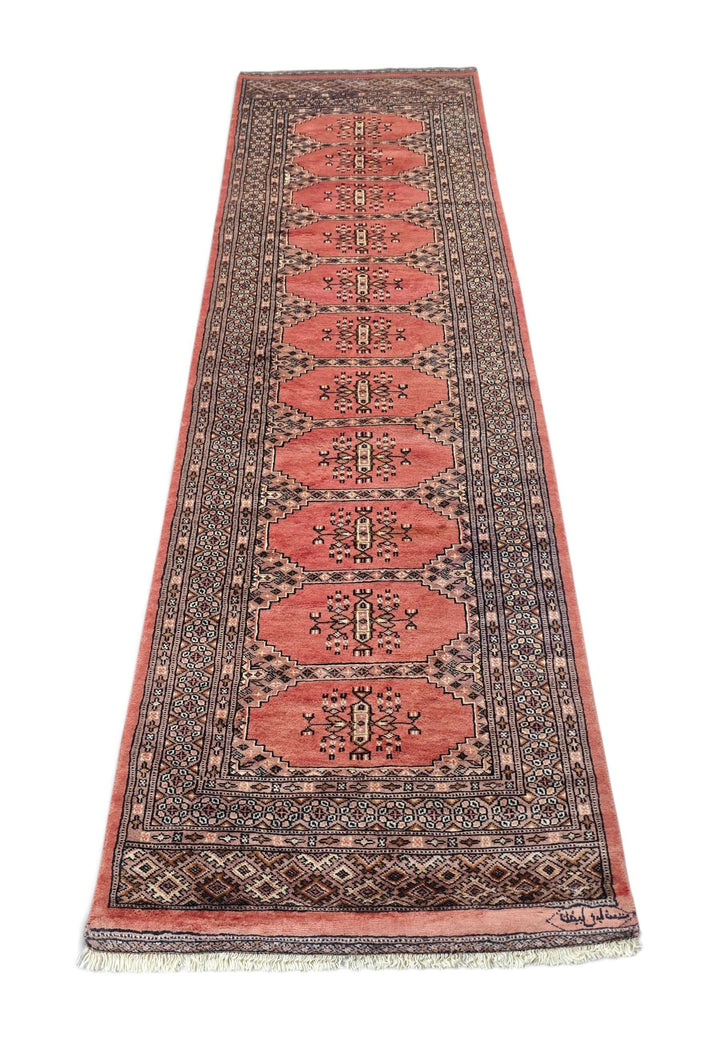Border detail of salmon and ivory hand-knotted Bokhara runner