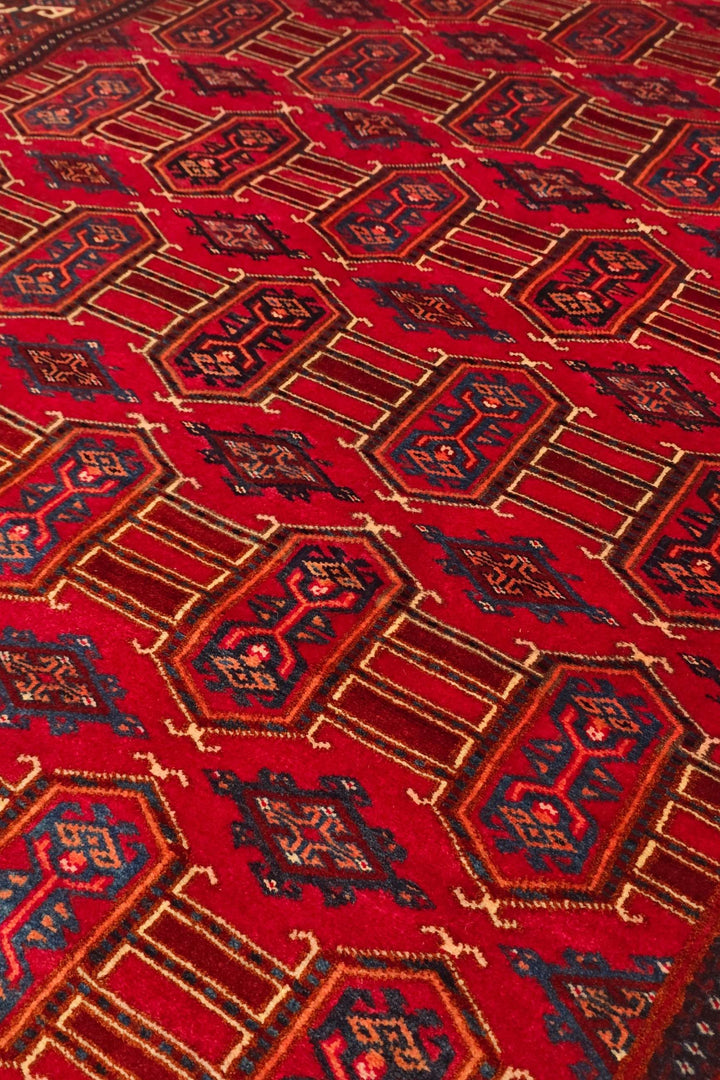 Turkmen panel design in deep red on Afghan Sherwan rug