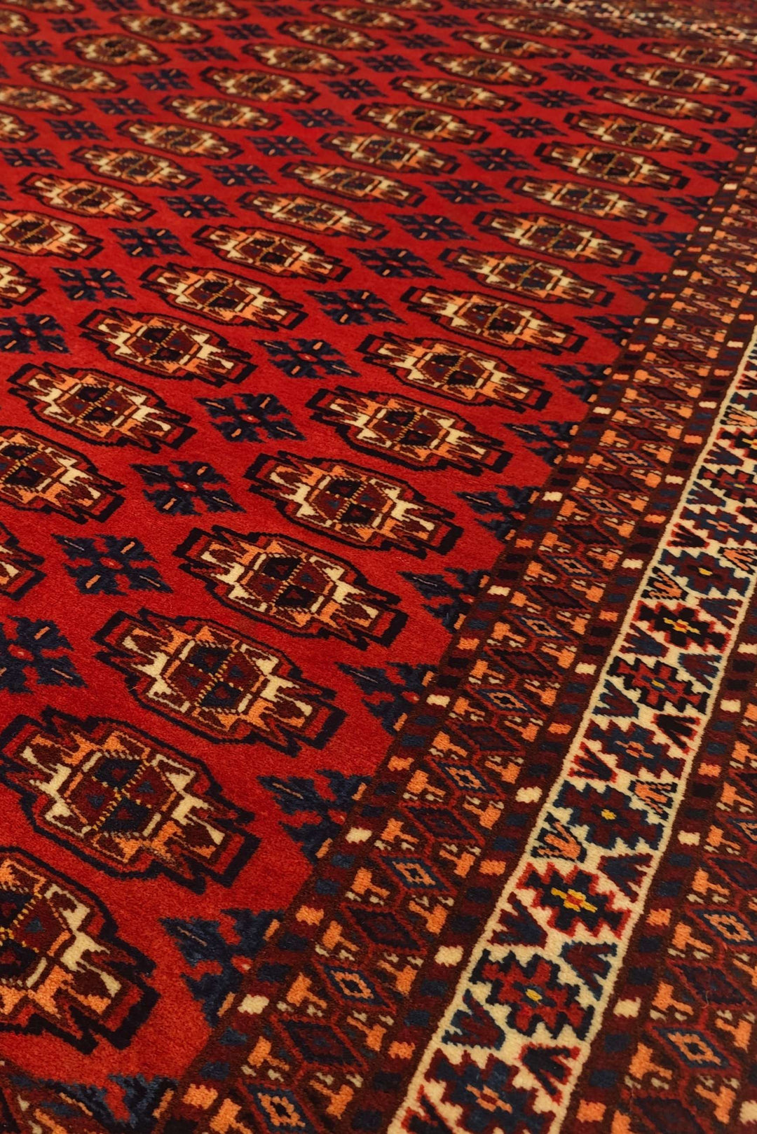 Bokhara gül motifs in red on Afghan Sherwan wool rug