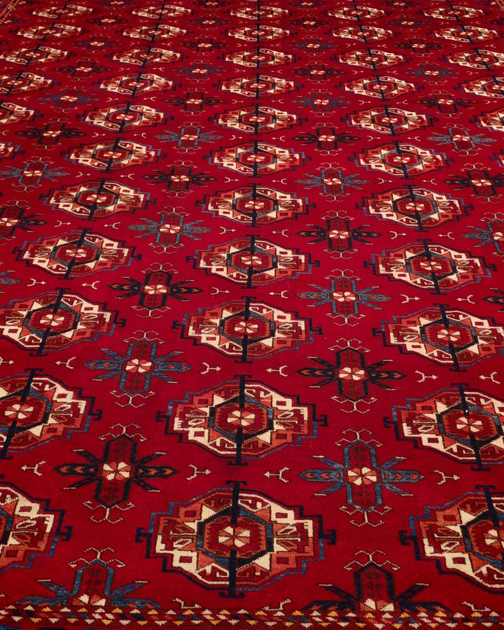 Hand-knotted wool pile of red Turkmen Bokhara Afghan rug