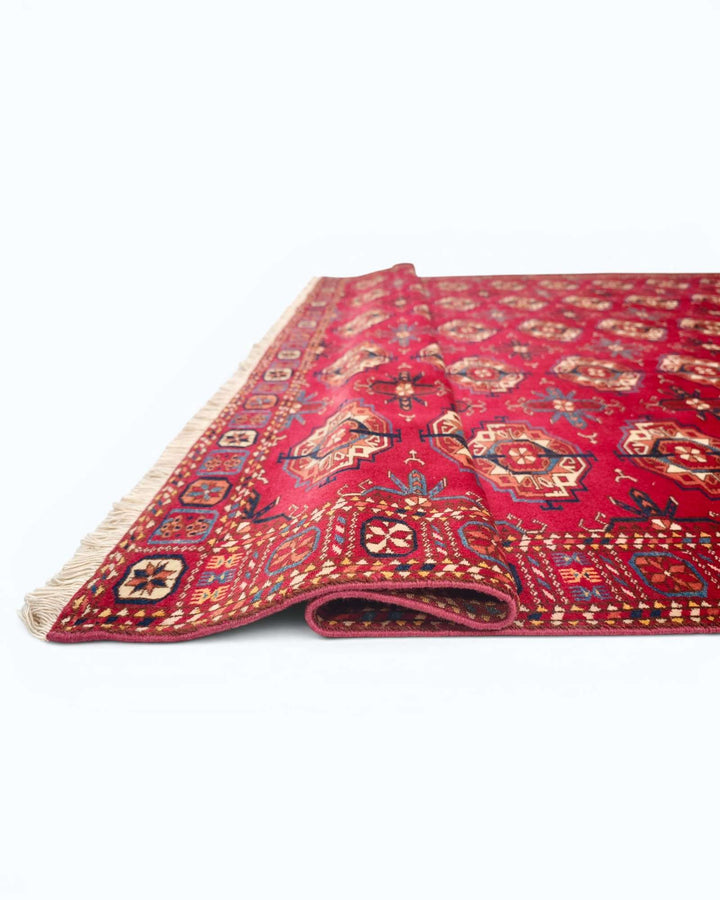 Hand-knotted red Afghan rug with Turkmen Bokhara güls