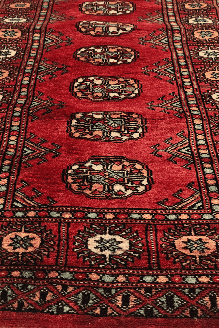 Red and salmon Turkmen gül rug for an entrance, 70×136cm