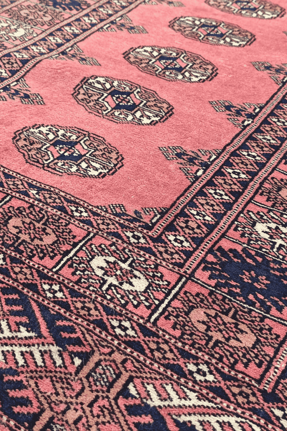 Single column of Turkmen güls in rose and navy on Bokhara runner