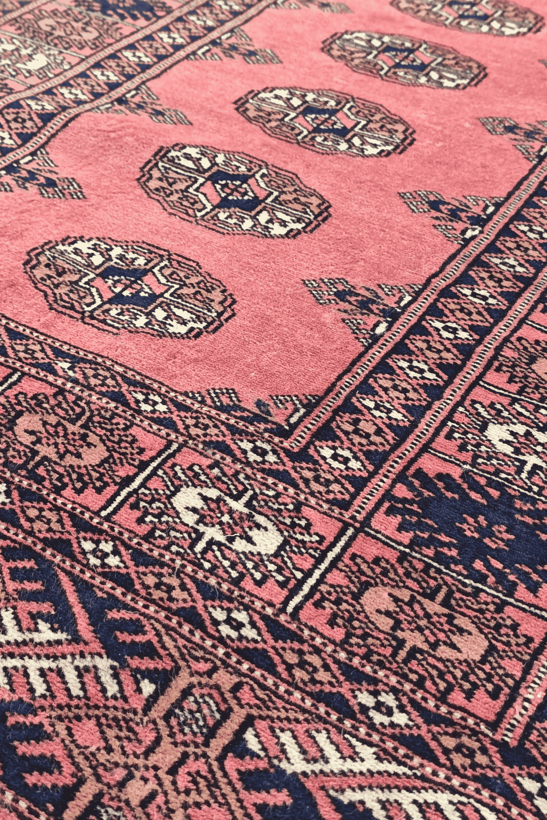 Single column of Turkmen güls in rose and navy on Bokhara runner