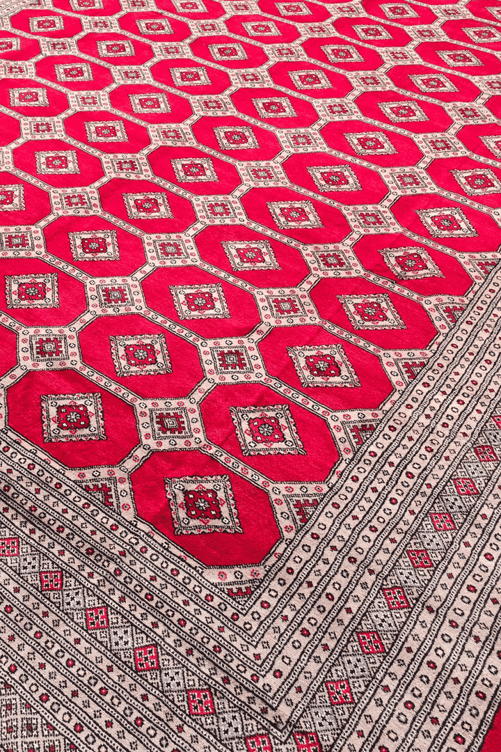 Diamond lattice detail on ruby red Pakistani Bokhara wool rug