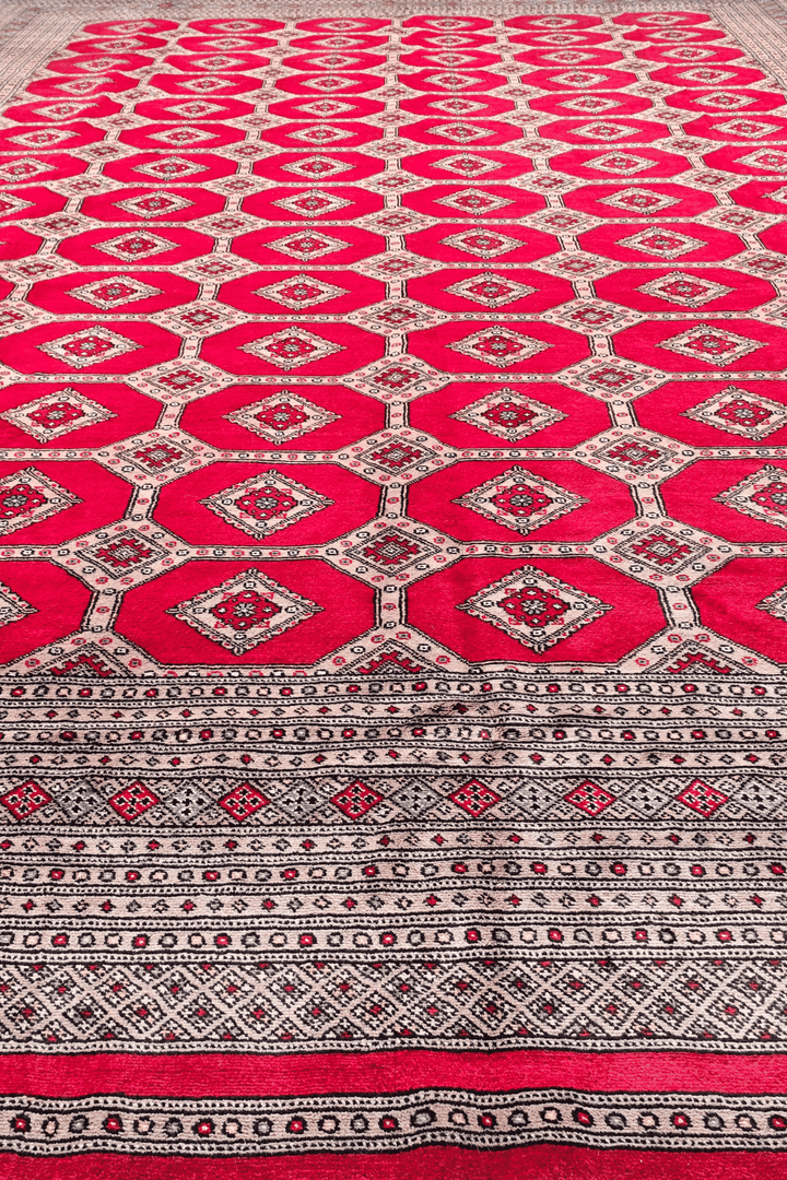 Hand-knotted ruby red Bokhara rug with diamond lattice field