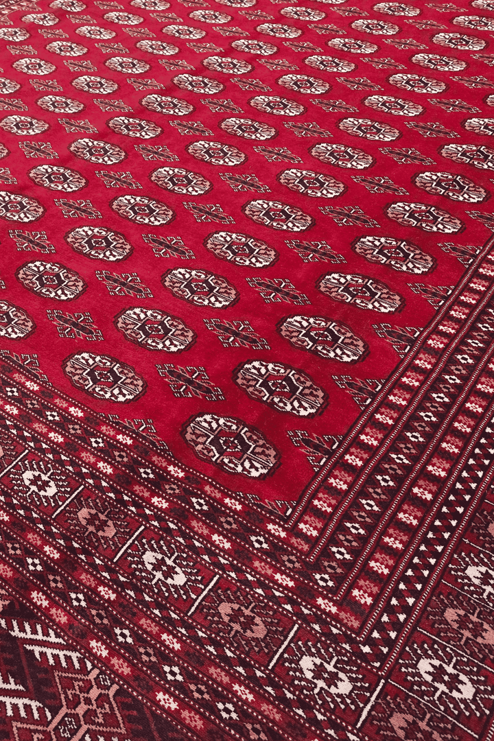Turkmen gül motifs on ruby red Pakistani Bokhara wool rug