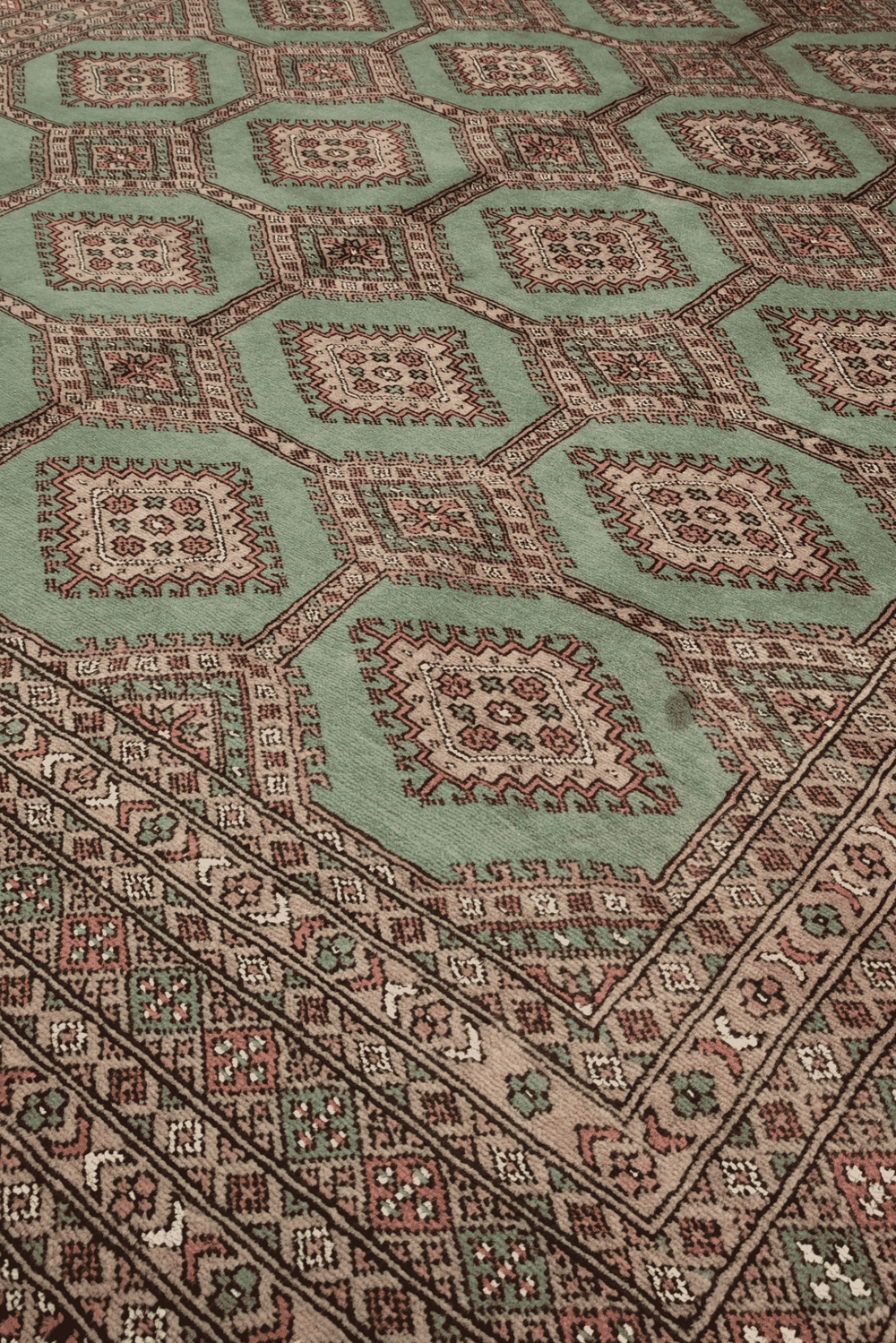 Compartment lattice detail in sage green and taupe on Bokhara rug