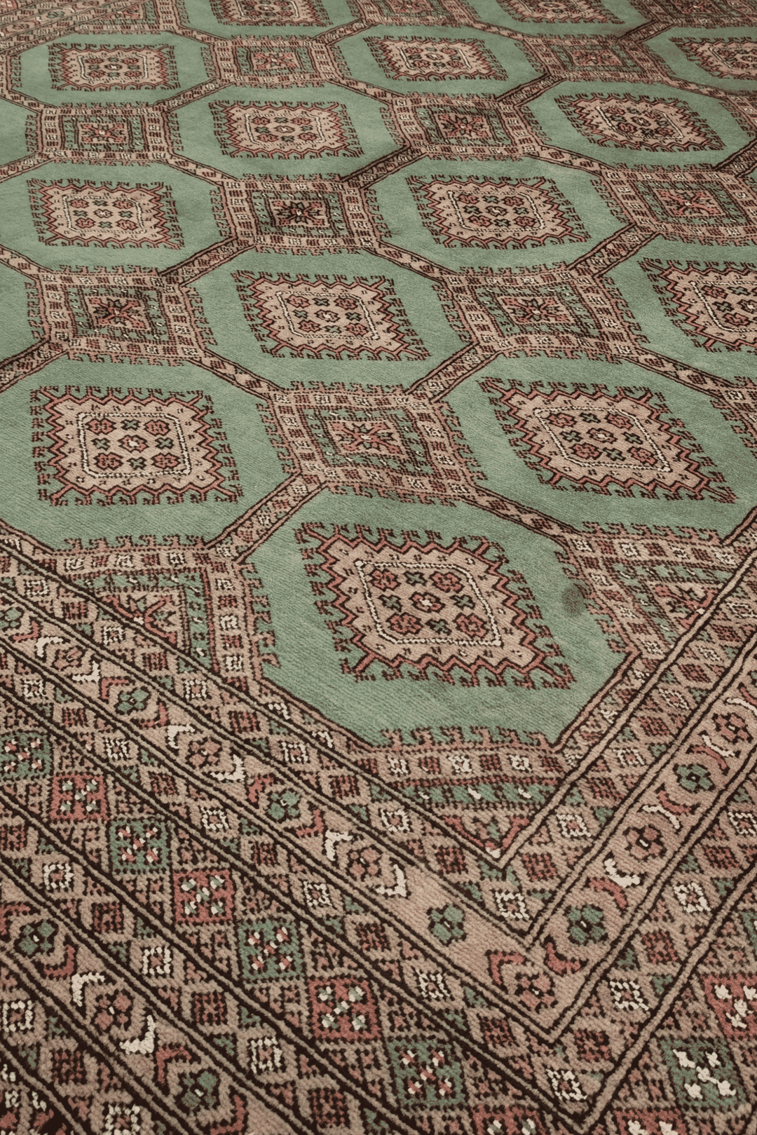 Compartment lattice detail in sage green and taupe on Bokhara rug