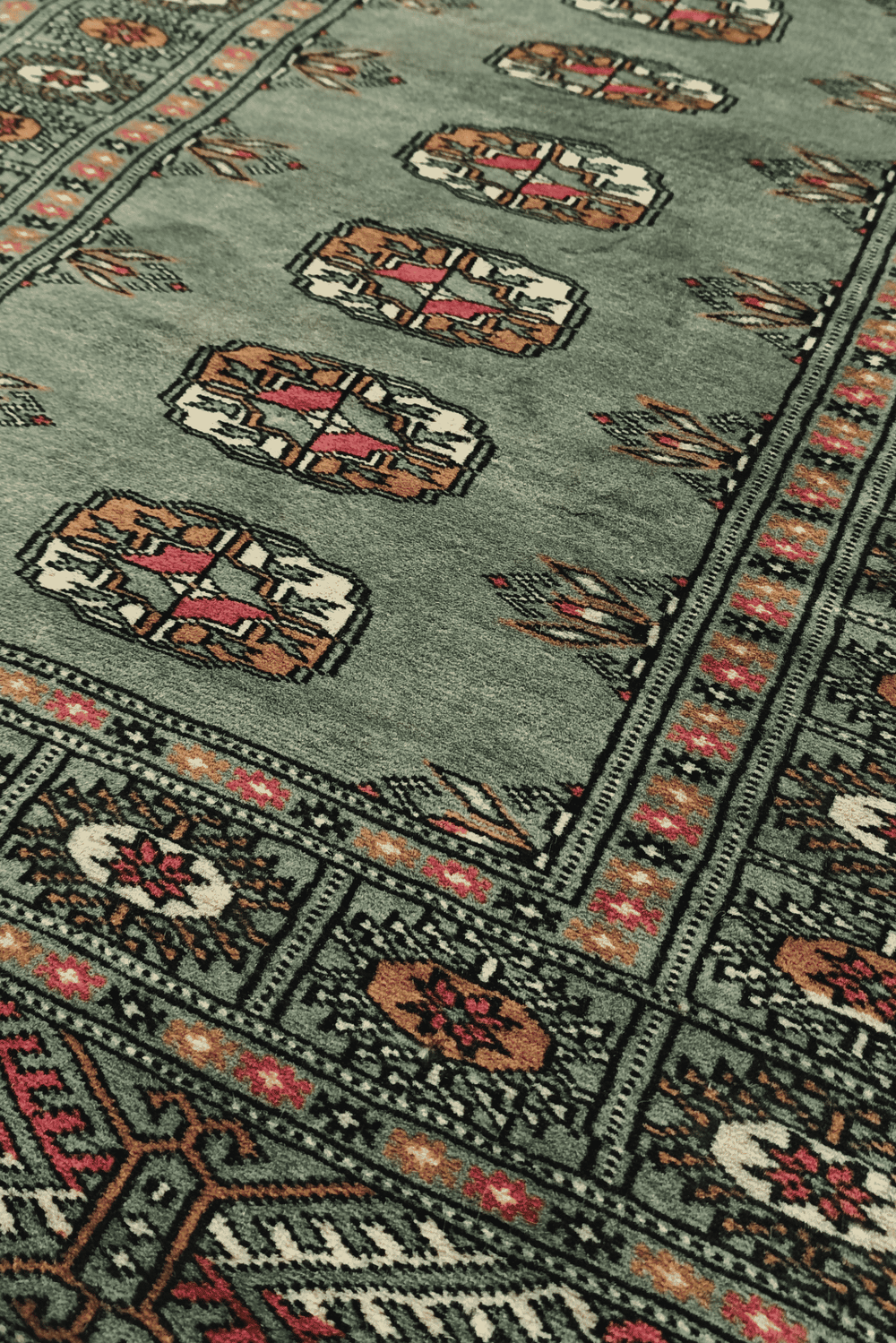 Single column of Turkmen güls in sage and gold on Bokhara runner