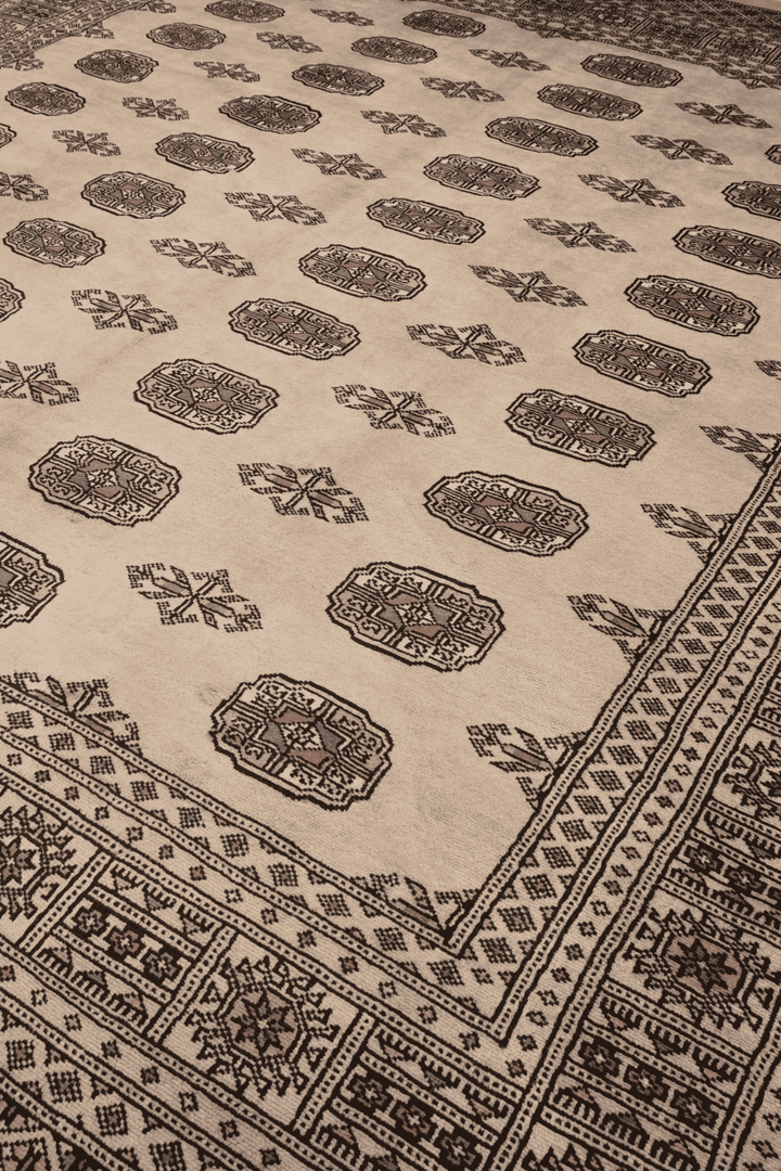 Turkmen gül motifs on sand beige Pakistani Bokhara wool rug