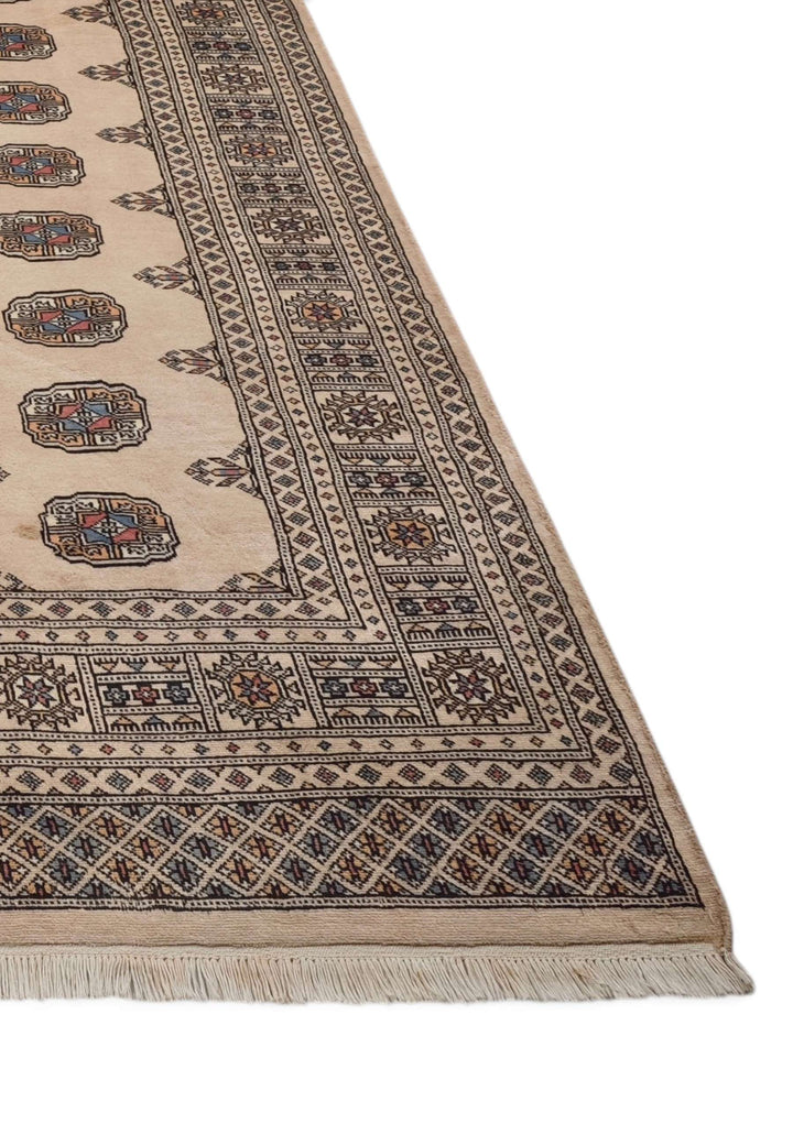 Hand-knotted sand beige Bokhara rug with repeating Turkmen güls