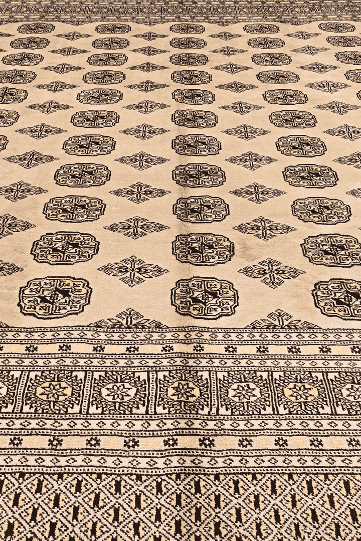 Border detail of sand beige hand-knotted square Bokhara rug