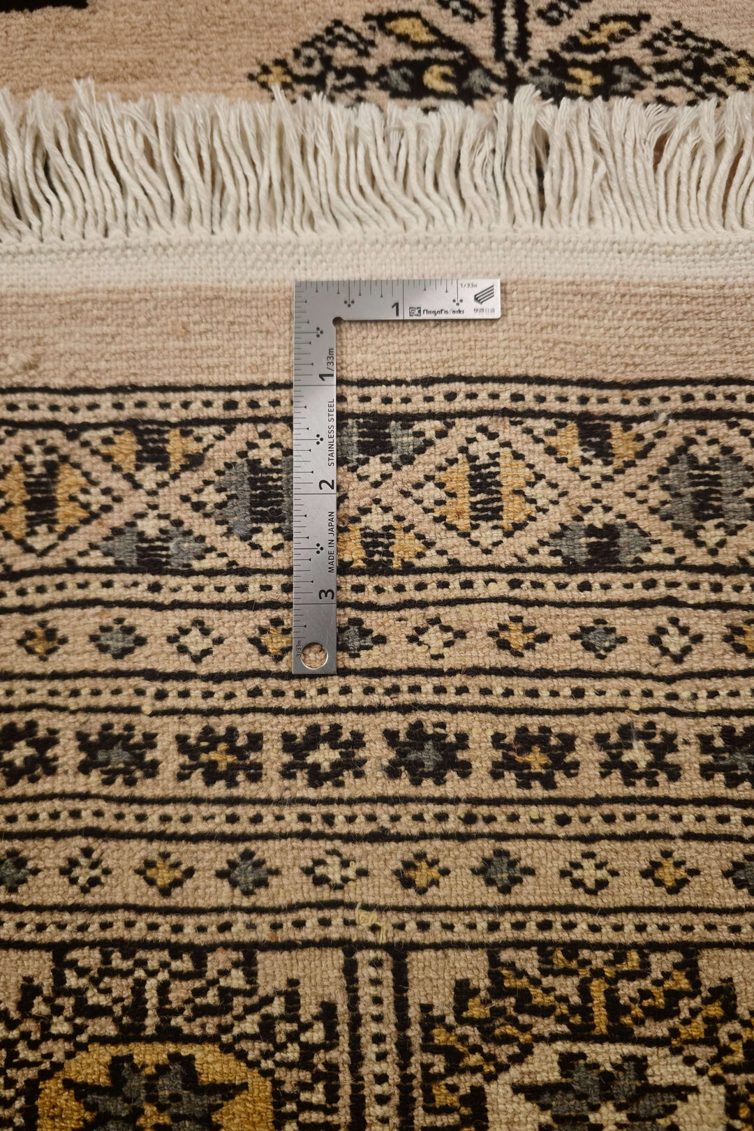 Hand-knotted sandy beige Bokhara rug with gold Turkmen güls