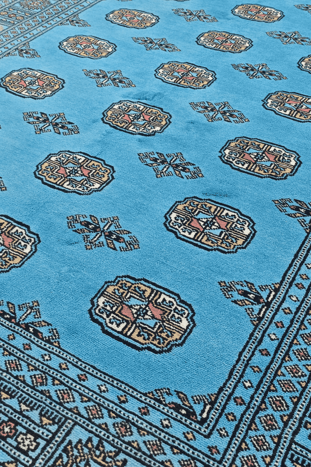 Turkmen gül motifs in turquoise and ivory on Pakistani Bokhara rug