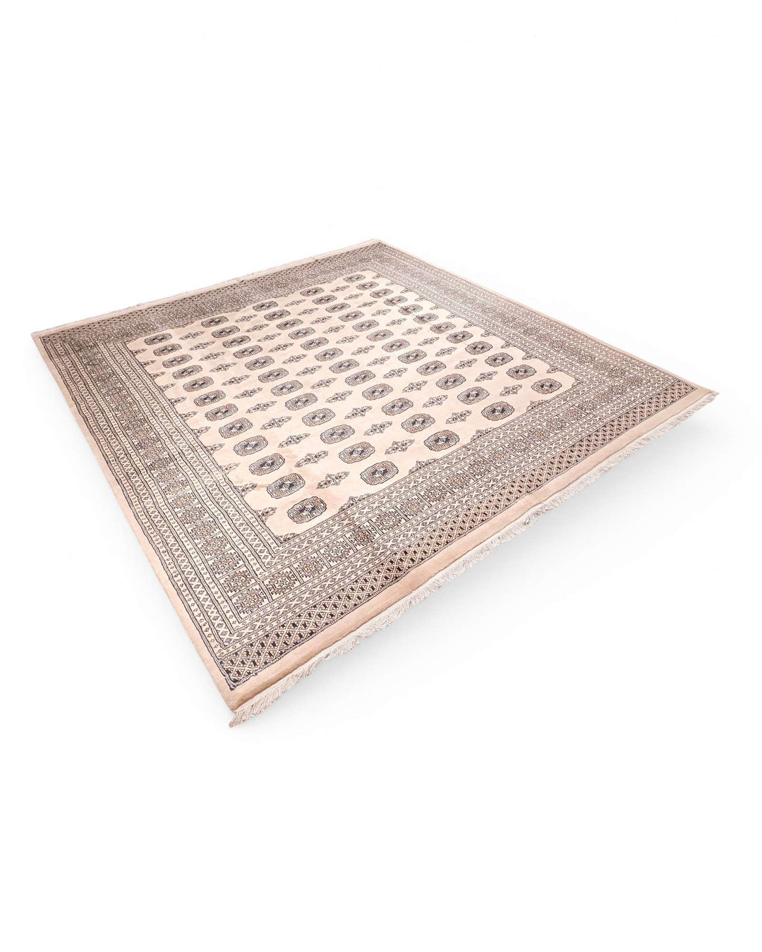 Corner of warm beige Pakistani Bokhara hand-knotted rug