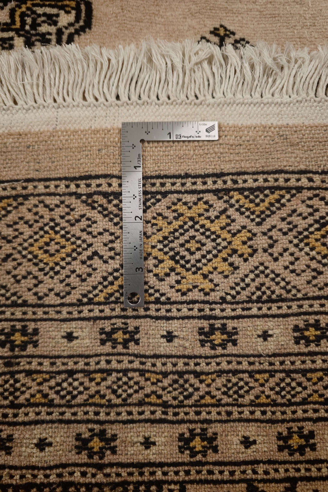 Hand-knotted warm sand Bokhara rug with gold Turkmen güls