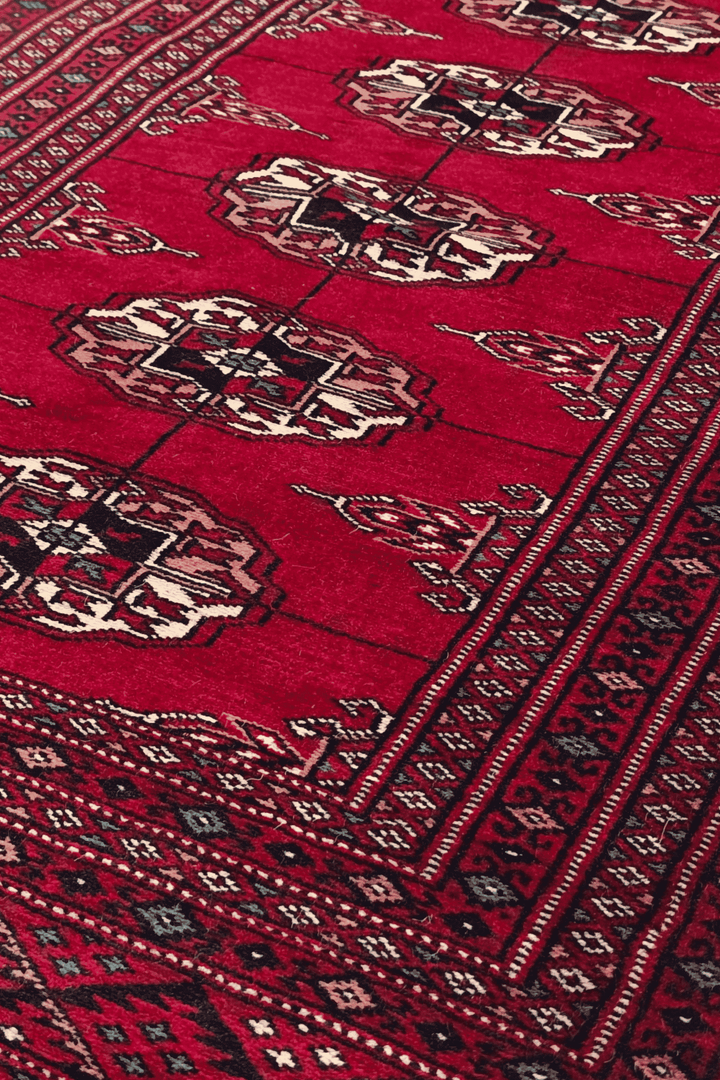 Threaded gül motifs in wine red and cream on Bokhara rug