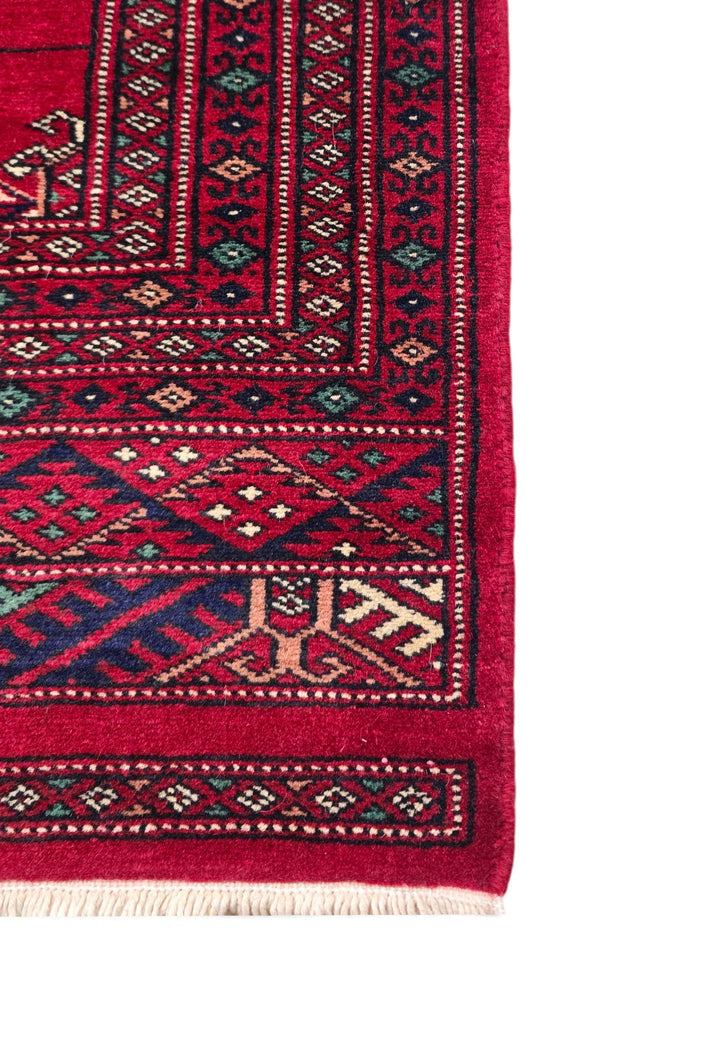 Hand-knotted wine red Bokhara rug with threaded gül design