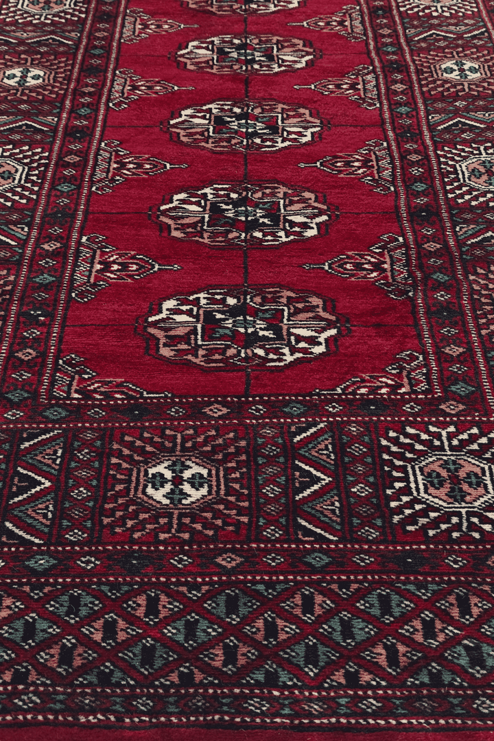 Hand-knotted wine red Bokhara runner with cream Turkmen güls
