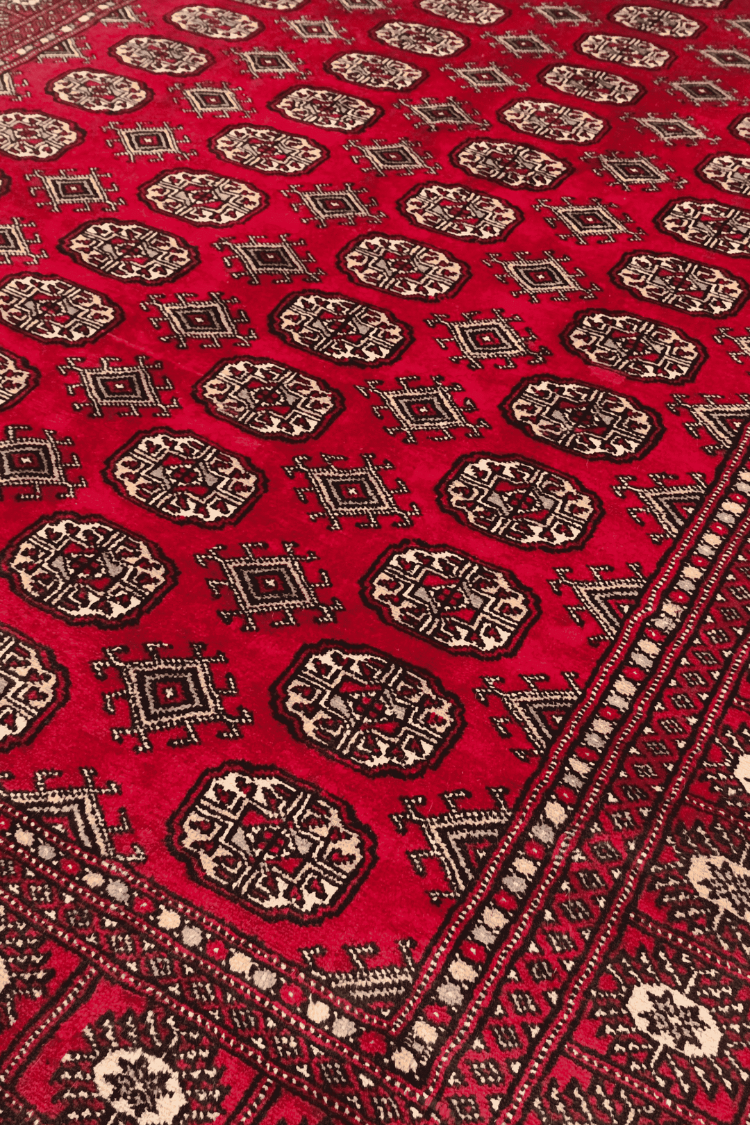 Turkmen gül motifs on wine red Pakistani Bokhara wool rug