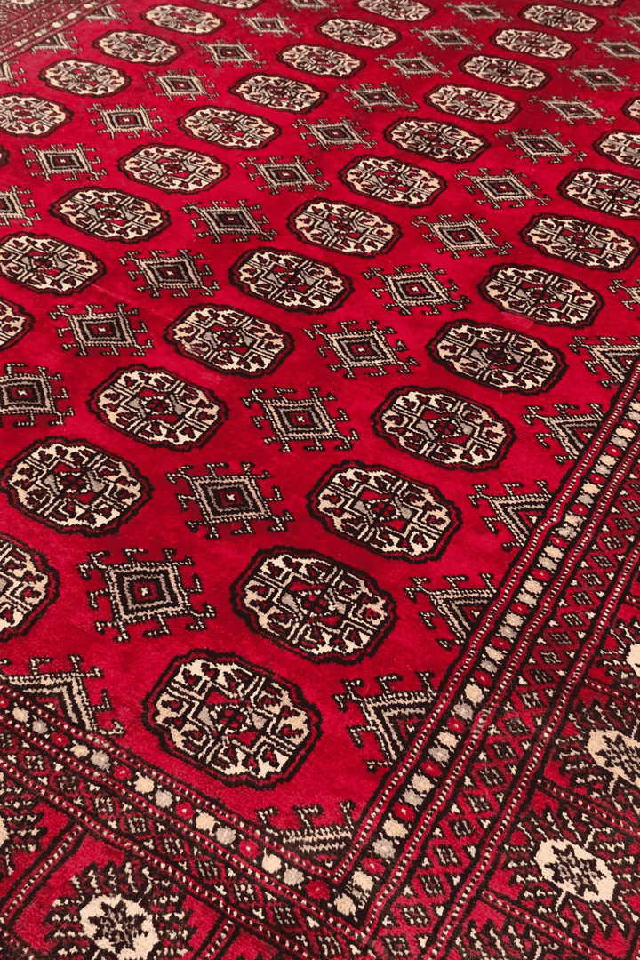 Turkmen gül motifs on wine red Pakistani Bokhara wool rug