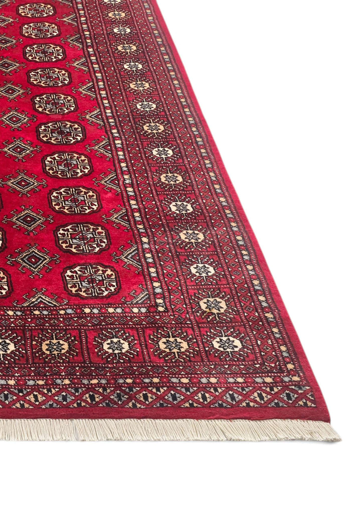 Hand-knotted wine red Bokhara rug with repeating Turkmen güls