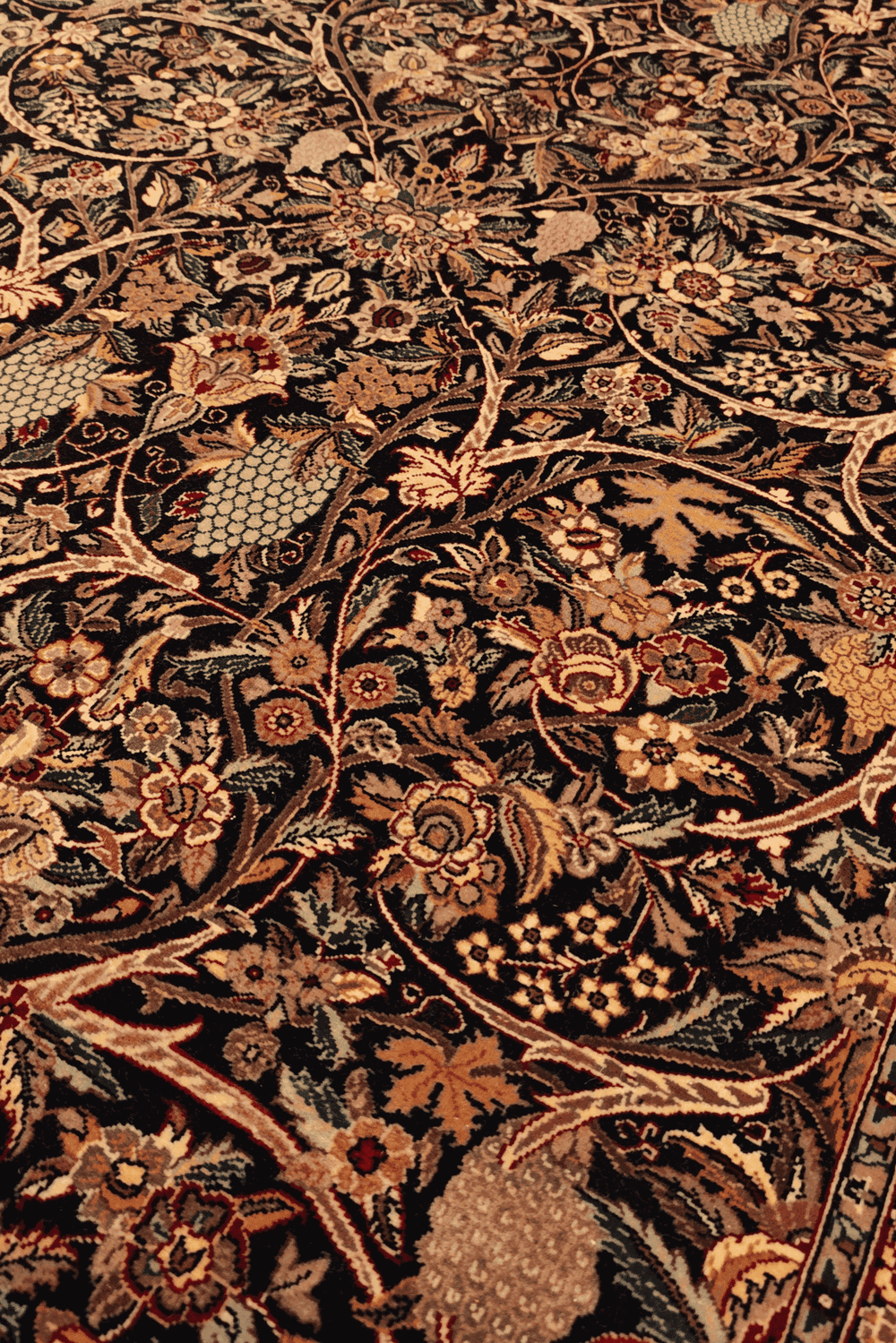 Garden floral detail in midnight blue on Tabriz rug