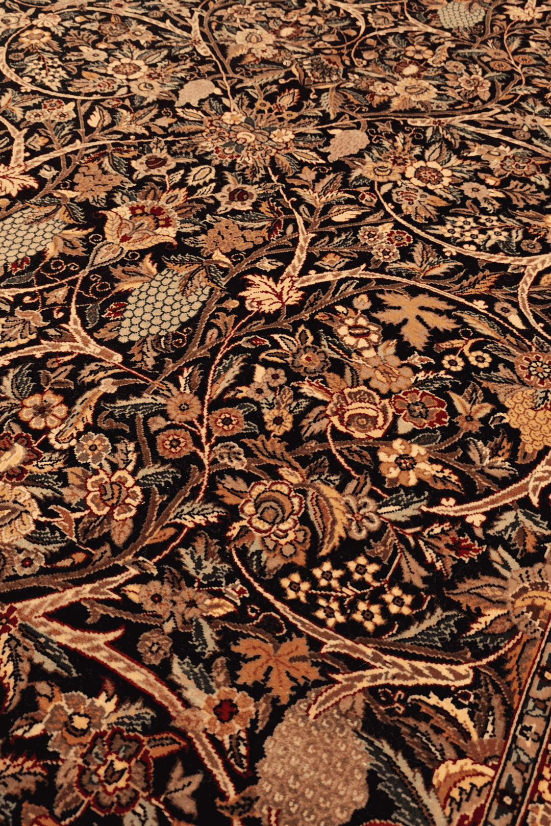 Garden floral detail in midnight blue on Tabriz rug