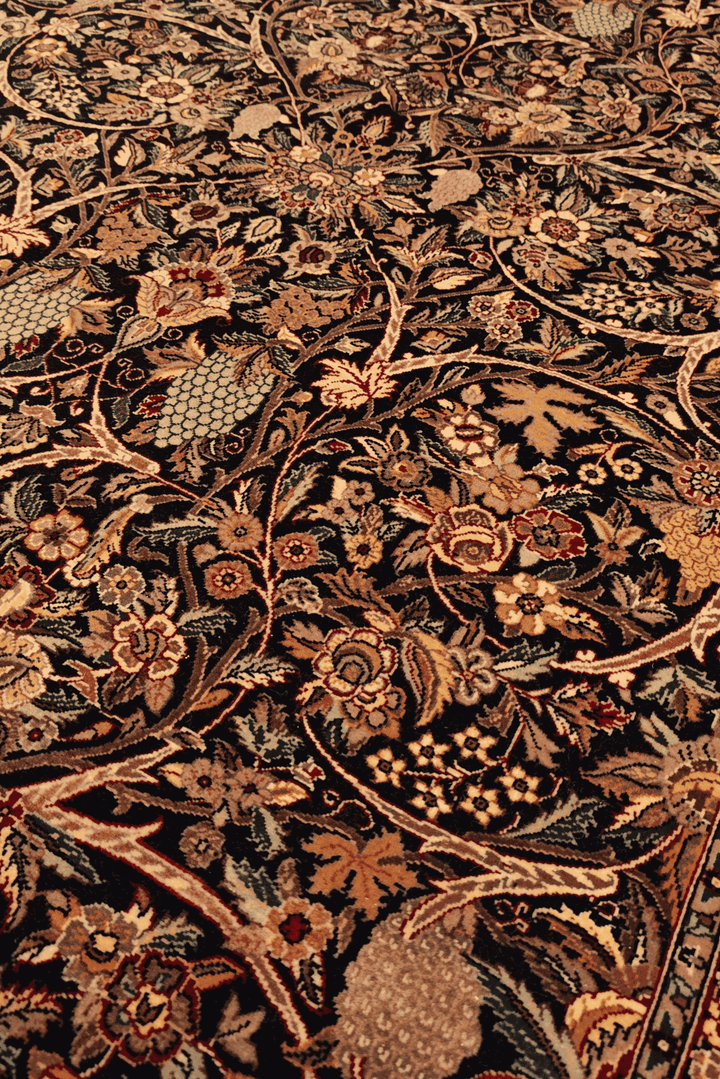 Garden floral detail in midnight blue on Tabriz rug