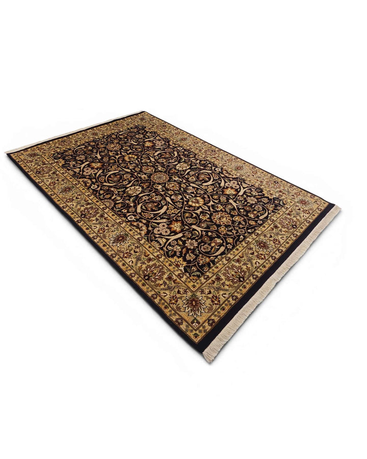 Hand-knotted ebony rug with gold Tabriz floral field