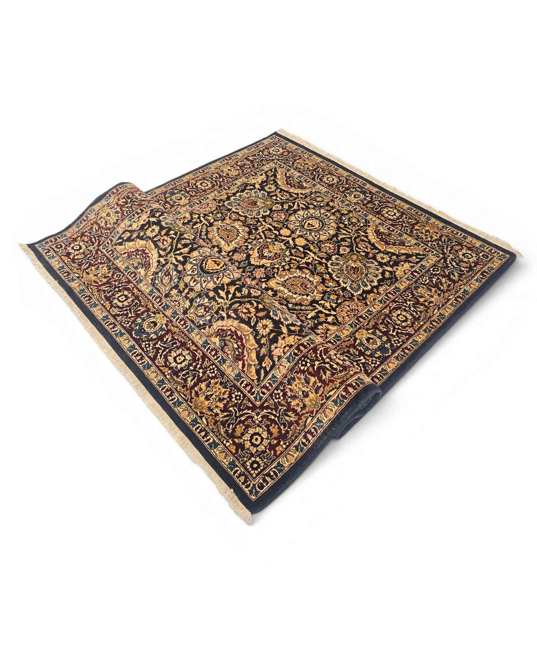 Corner of jet black gold Tabriz Pakistani double-knot rug