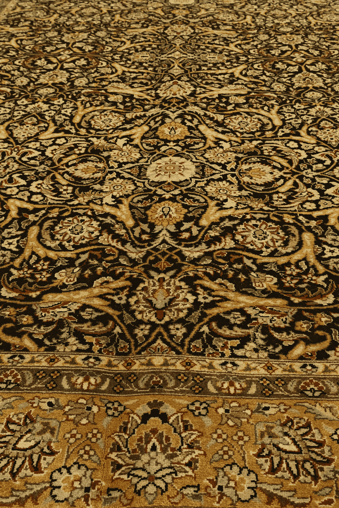 Fringe of black and gold floral vine hand-knotted rug