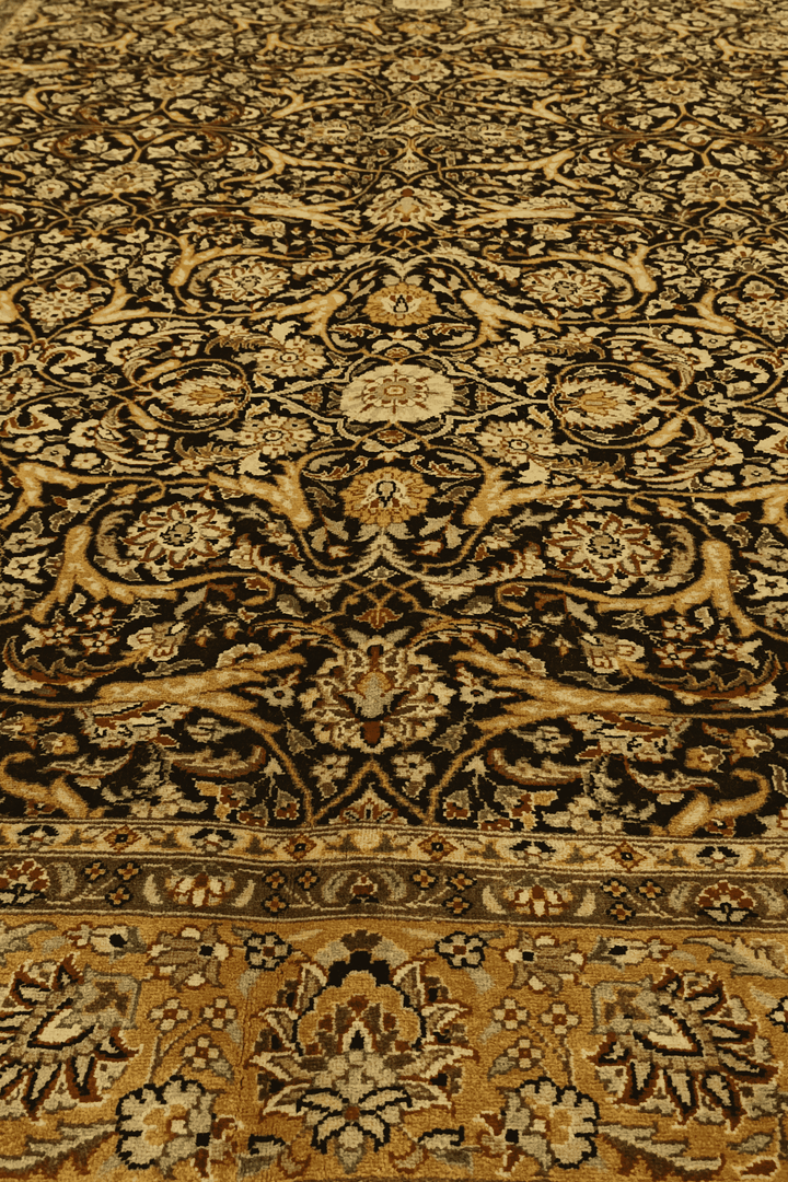 Fringe of black and gold floral vine hand-knotted rug