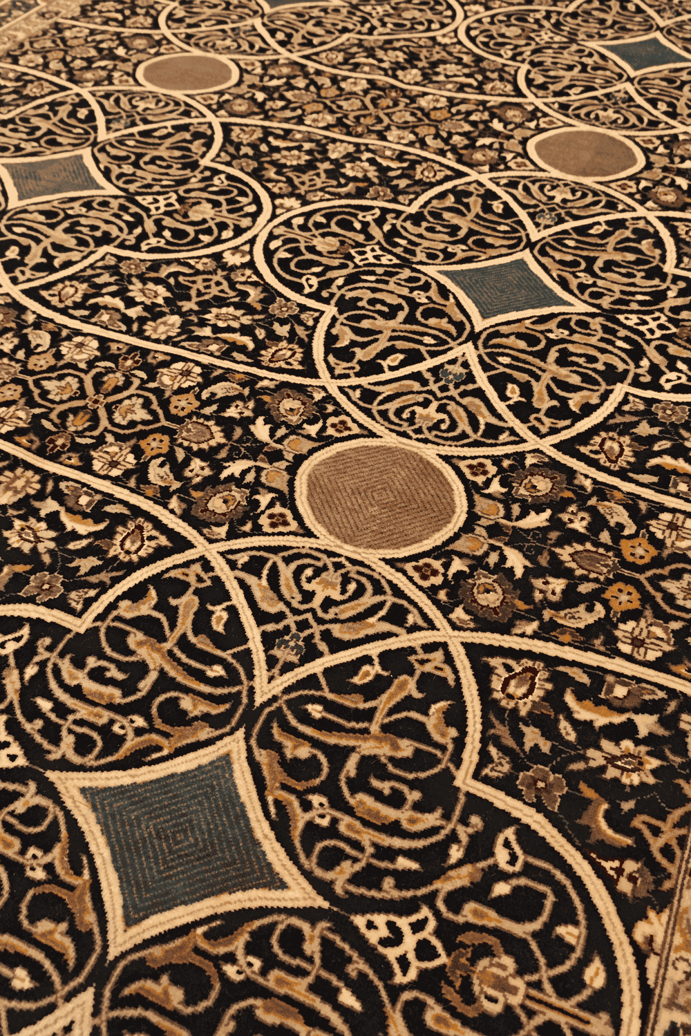 Arabesque lattice detail in camel on Pakistani rug