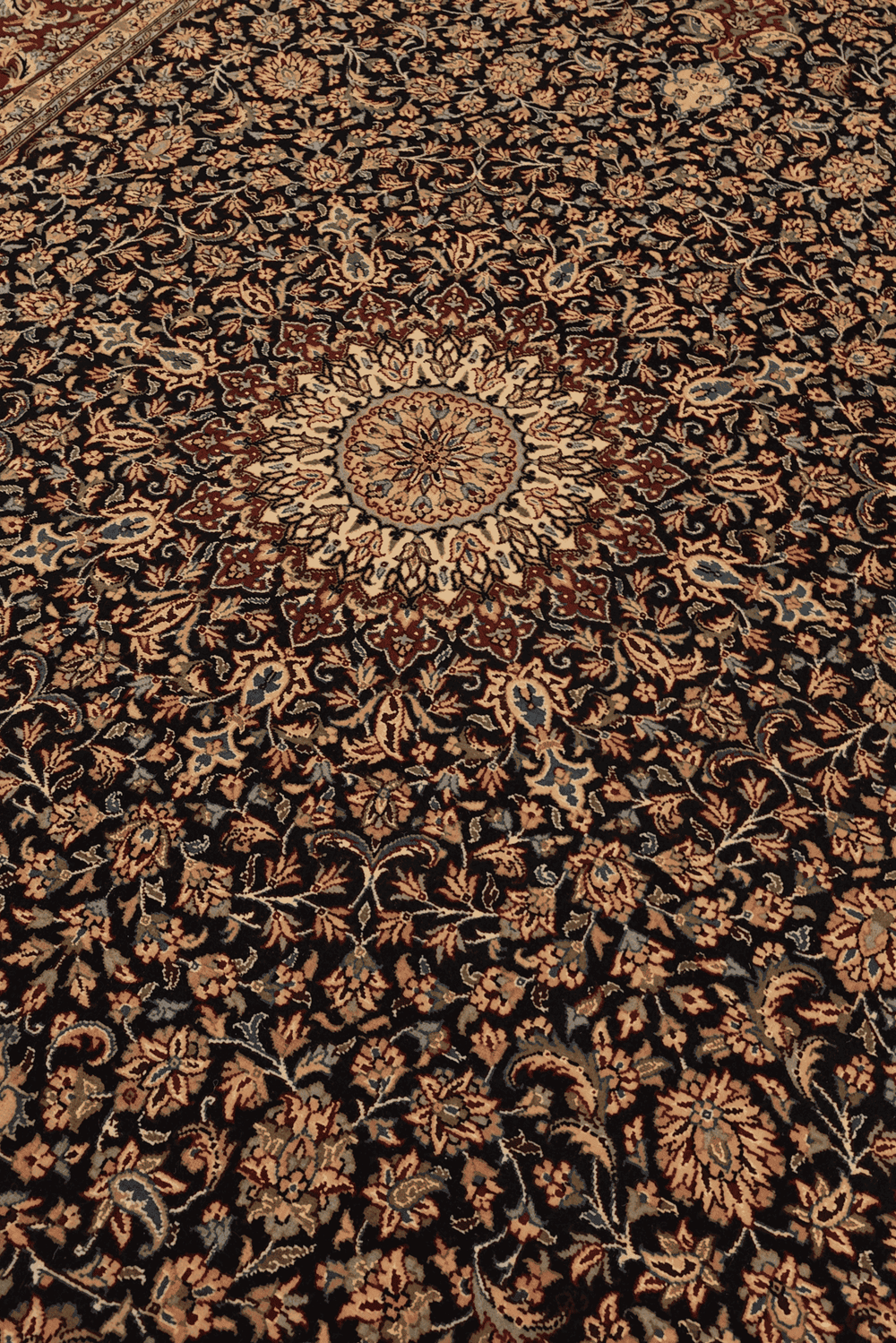 Medallion detail in obsidian and claret on Tabriz rug