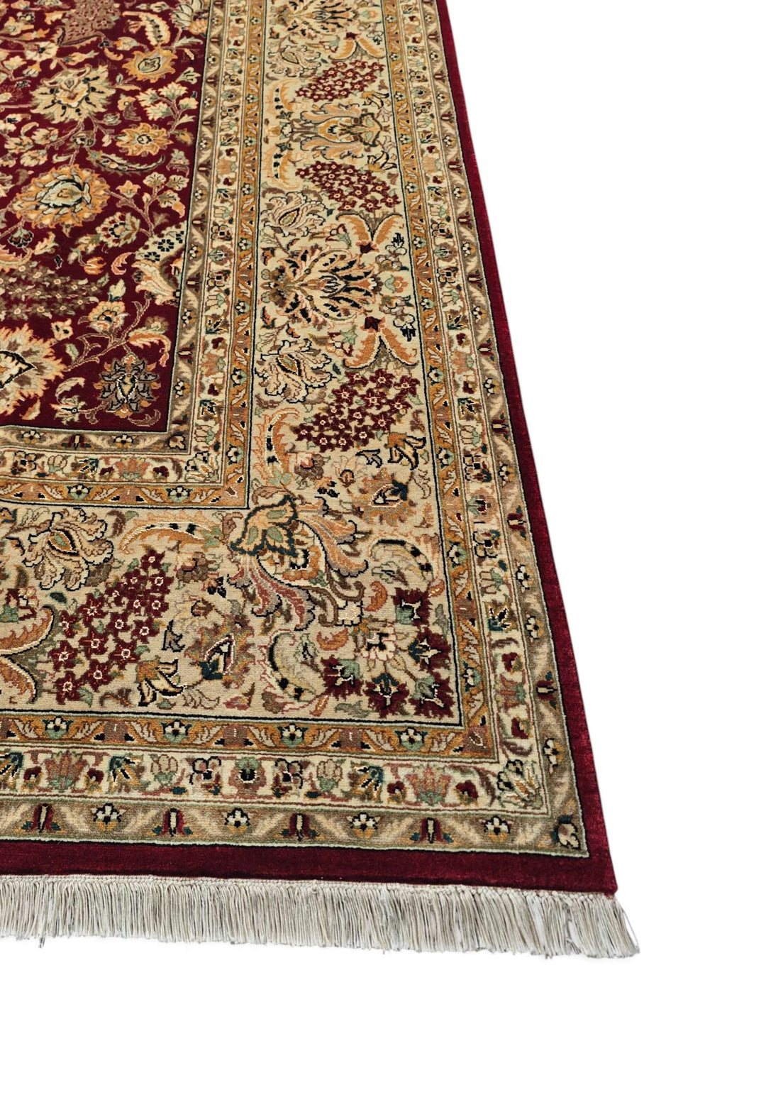 Corner of burgundy and camel Shah Abbasi wool rug